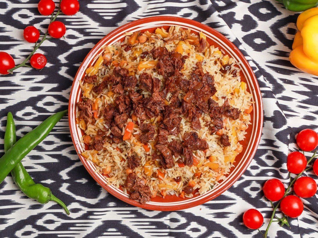 Plov on a traditional ceramic plate
